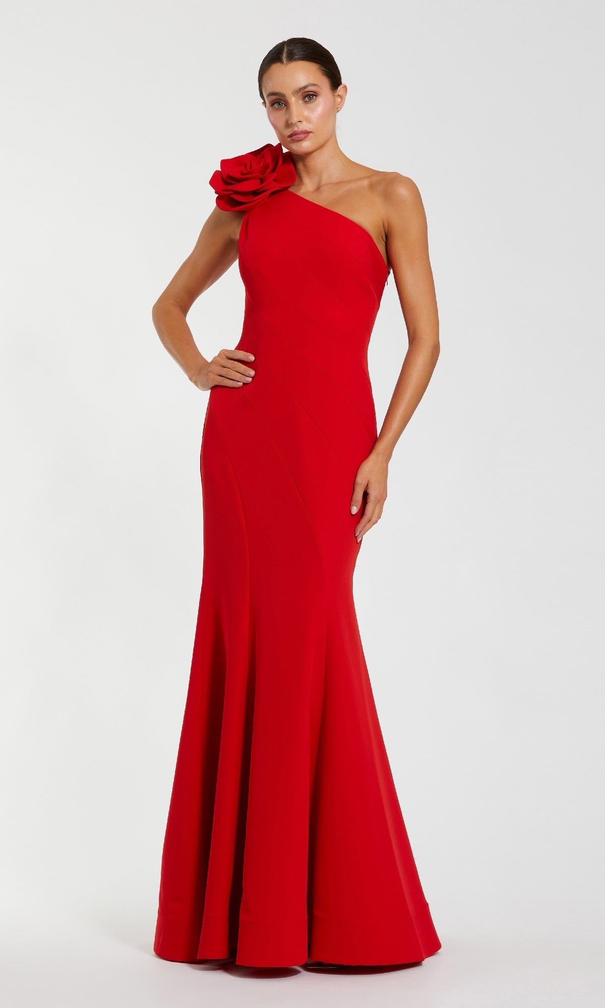 Red one-shoulder evening gown with floral detail on a white background